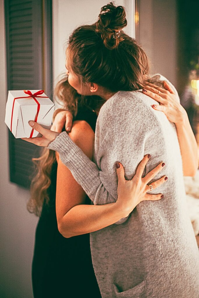 two woman hugging each other